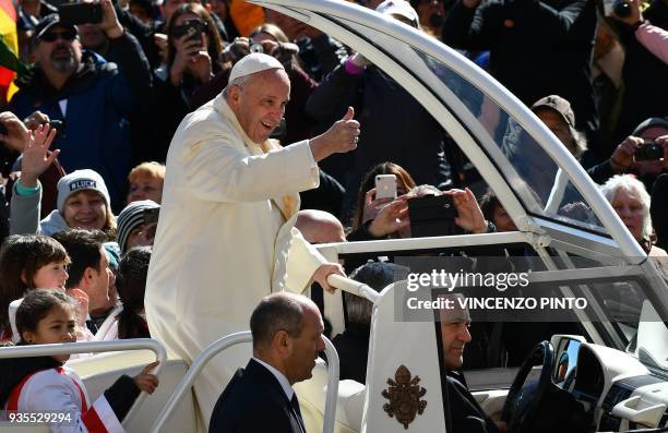 Pope Francis thumbs up as he waves to faithful upon his arrival in St Peter's square in Vatican, for his weekly general audience on March 21, 2018. /...