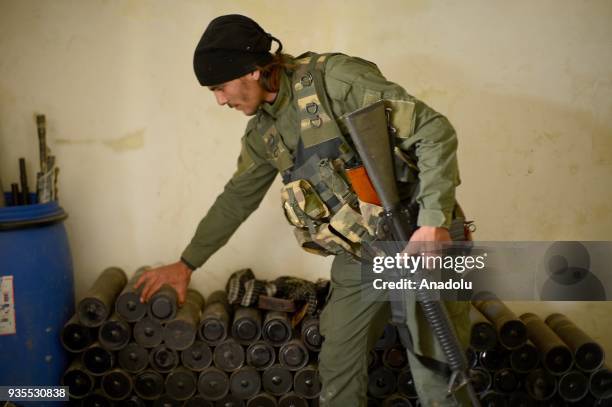 Member inspects ammunitions after Turkish military and Free Syrian Army uncover ammunition depot as the search operations continue after Turkish...