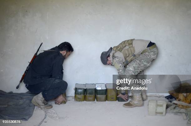 Members inspect ammunitions after Turkish military and Free Syrian Army uncover ammunition depot as the search operations continue after Turkish...