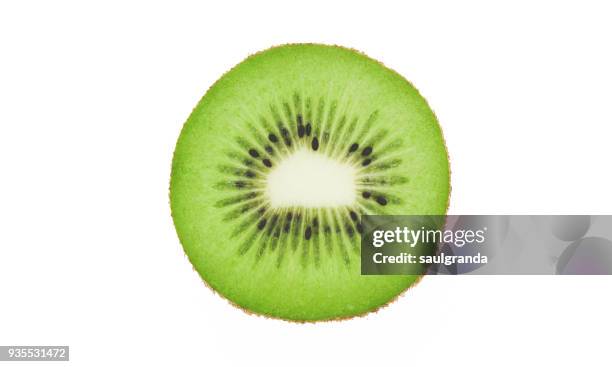 kiwi slice against white background - kiwi fruit stock pictures, royalty-free photos & images