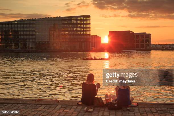 sunset in copenhagen - moving down to seated position stock pictures, royalty-free photos & images