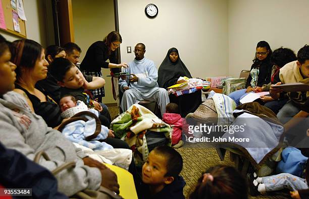 Abdi Mohammed, an immigrant from Somalia, completes forms ahead of a newborn care class at a community health center for low-income patients on...
