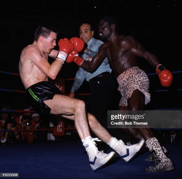 Jim McDonnell of Great Britain is knocked down by Azumah Nelson of Ghana, watched by Referee Joe Cortez during their WBC World Super Featherweight...