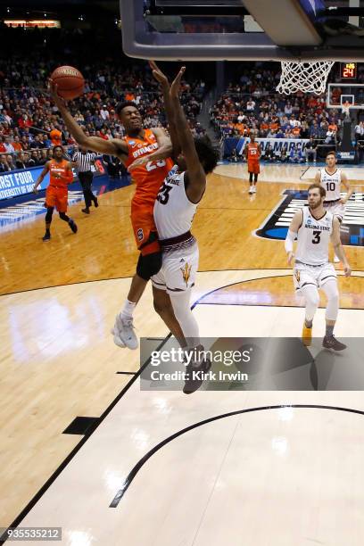 Tyus Battle of the Syracuse Orange attempts to shoo the ball over the defense of Romello White of the Arizona State Sun Devils during the game at UD...