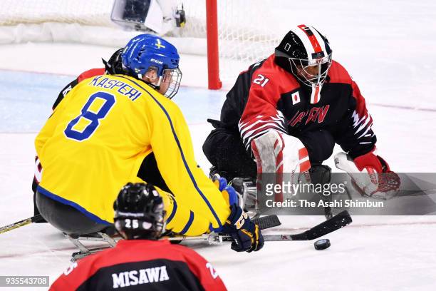 Shinobu Fukushima of Japan and Per Kasperi of Sweden compete for the puck during classigication game 7/8th on day seven of the PyeongChang 2018...