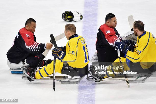Players shake hands after classigication game 7/8th on day seven of the PyeongChang 2018 Paralympic Games on March 16, 2018 in Pyeongchang-gun, South...