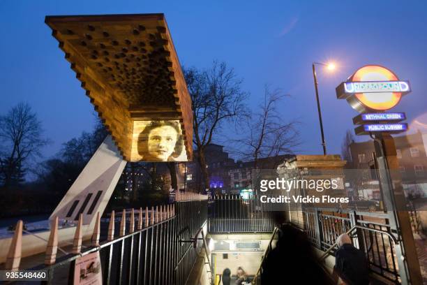 Photographic projections of the victims of the Bethnal Green tube disaster are projected onto the Stairway to Heaven memorial next to the Bethanal...