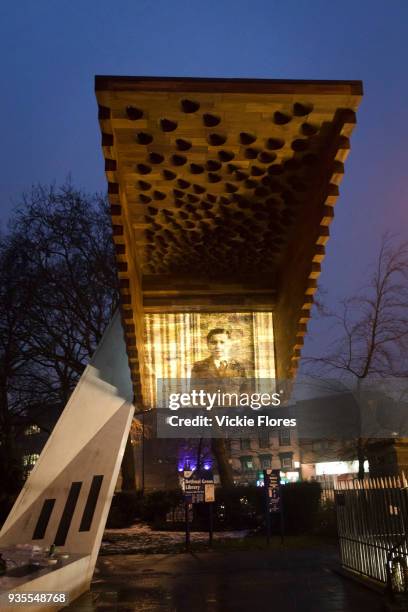 Photographic projections of the victims of the Bethnal Green tube disaster are projected onto the Stairway to Heaven memorial next to the Bethanal...