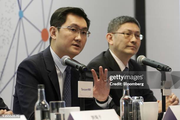 Ma Huateng, chairman and chief executive officer of Tencent Holdings Ltd., left, speaks as John Lo, chief financial officer, looks on during a news...