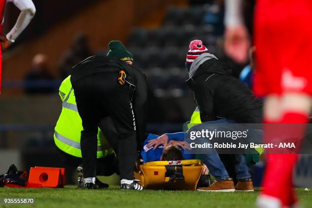 Andy Cannon of Rochdale goes off injured during the Sky Bet League One match between Rochdale and Fleetwood Town at Spotland Stadium on March 20,...