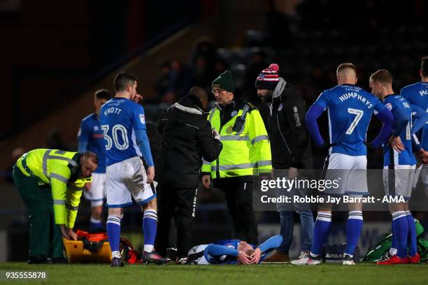 Andy Cannon of Rochdale goes off injured during the Sky Bet League One match between Rochdale and Fleetwood Town at Spotland Stadium on March 20,...