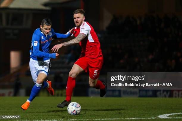 Mihal Dobre of Rochdale and Ashley Eastham of Fleetwood Town during the Sky Bet League One match between Rochdale and Fleetwood Town at Spotland...