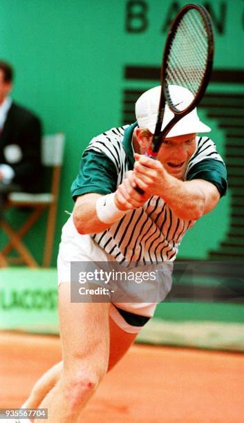 Jim Courier follows through with a powerful backhand to Dutch opponent Richard Krajicek during their French Open semi-final match 04 June. Courier...