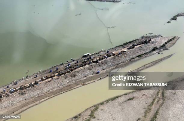 An aerial view shows tents of flood-displaced people surrounded by water in southern Sehwan town on February 7, 2011. United Nations Framework...