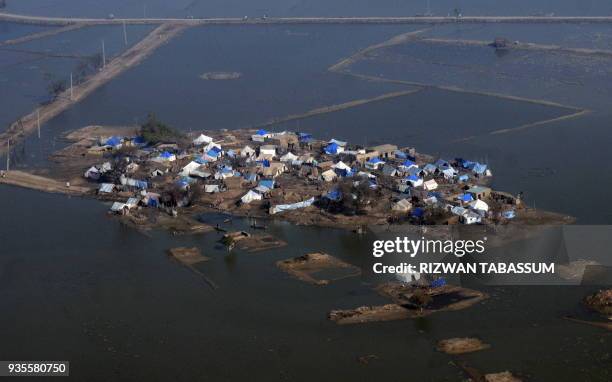 An aerial view shows tents of flood-displaced people surrounded by water in southern Sehwan town on February 7, 2011. United Nations Framework...