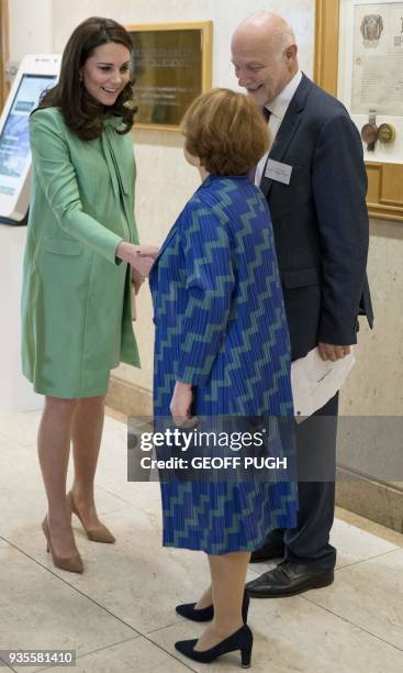 Britain's Catherine, Duchess of Cambridge is greeted by Chief Executive at The Anna Freud Centre, Peter Fonagy and Lorraine Heggessey on her arrival...