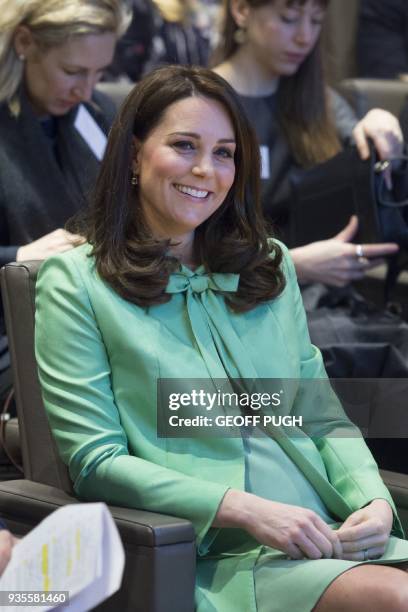 Britain's Catherine, Duchess of Cambridge gestures during a symposium she convened on early intervention for children and families with The Royal...