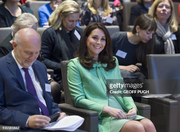Britain's Catherine, Duchess of Cambridge gestures during a symposium she convened on early intervention for children and families with The Royal...
