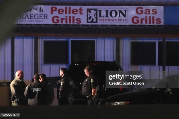 Law enforcement officials investigate at the location where the suspected package bomber was killed in suburban Austin on March 21, 2018 in Round...