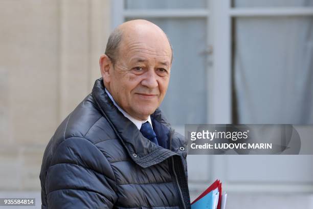 French Foreign Affairs Minister Jean-Yves Le Drian leaves after the weekly Cabinet meeting on March 21, 2018 at the Elysee palace in Paris. / AFP...