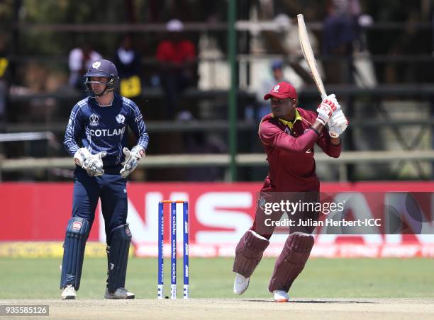 Matthew Cross of Scotland looks on as Marlon Samuels of the West Indies scores runs during The ICC Cricket World Cup Qualifier between the West...