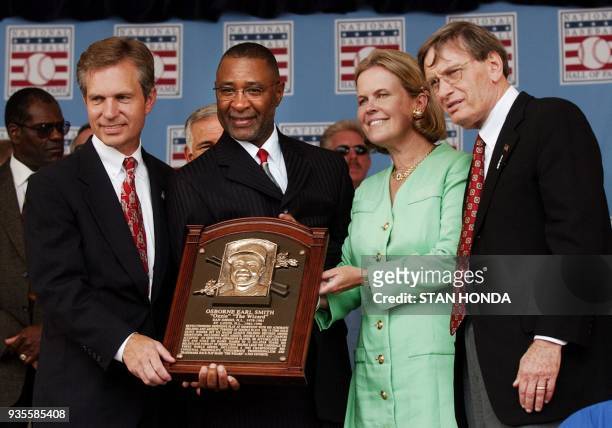 Former St. Louis Cardinals shortstop and Baseball Hall of Fame inductee Ozzie Smith hold his plaque with Dale A. Petroskey , president of the...