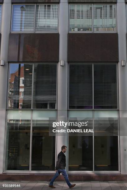 Windows in a shared office block, one with the words "Data", "Digital", and "Regulations?" are pictured on the second floor of a building which...