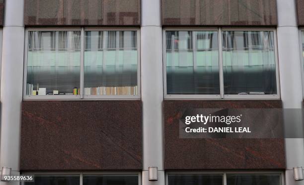 Windows in a shared office block, one with the words "Data", "Digital", and "Regulations?" are pictured on the second floor of a building which...