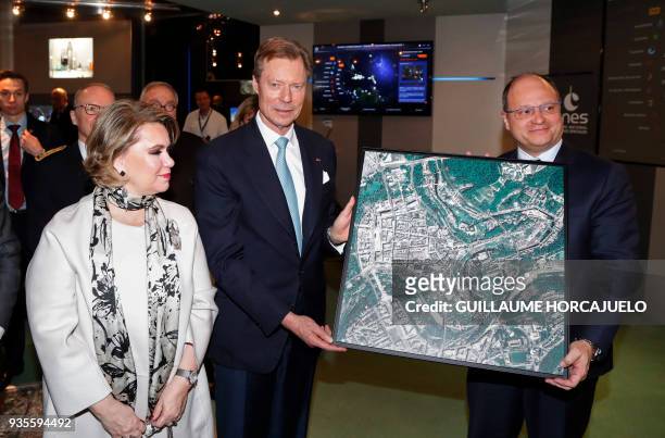 Grand Duchess Maria-Teresa of Luxembourg and Grand Duke Henri of Luxembourg receive a picture showing a satellite view of the city of Luxembourg,...