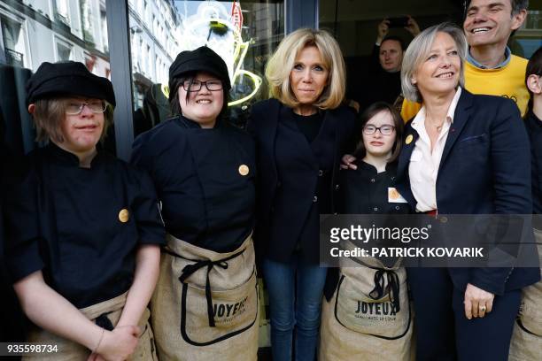 French President's wife Brigitte Macron and French Junior Minister for Disability Issues Sophie Cluzel pose with handicapped and autistics employees...