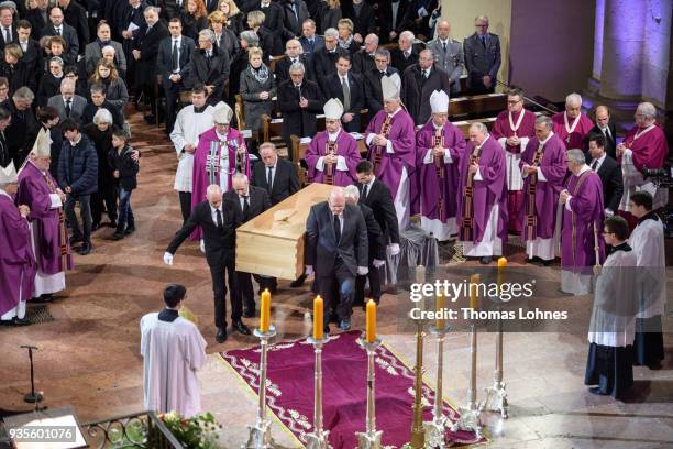 Pallbearers carry the coffin of Cardinal Karl Lehmann into the Mainzer Dom cathedral during the funeral service for Lehmann on March 21, 2018 in...