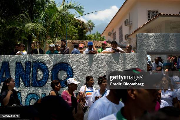 Supporters listen as Henri Falcon, presidential candidate for the Progressive Advance Party, not pictured, speaks during a press conference in...