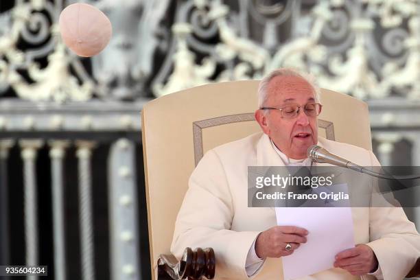 The biretta cup of Pope Francis is blown off his head by a gust of wind as he holds his weekly audience in St. Peter's Square on March 21, 2018 in...