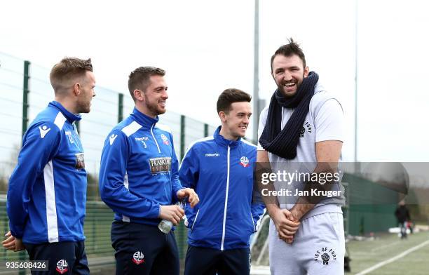 Hughie Fury chats with Zach Clough, Andrew Taylor and Craig Noone of Bolton during a media workout at Bolton Wanderers FC Academy on March 21, 2018...