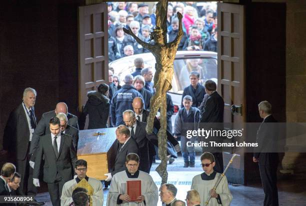 Pallbearers carry the coffin of Cardinal Karl Lehmann into the Mainzer Dom cathedral during the funeral service for Lehmann on March 21, 2018 in...