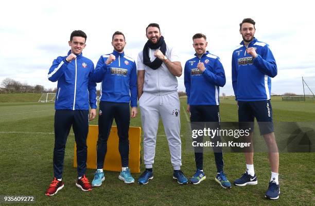 Hughie Fury poses with Zach Clough, Andrew Taylor, Craig Noone and William Buckley of Bolton during a media workout at Bolton Wanderers FC Academy on...