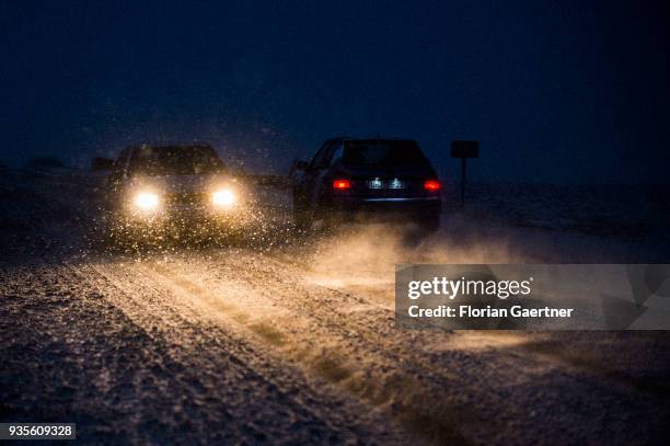 Two cars drive through a snow storm in the evening on March 17, 2018 in Frydlant, Czech Republic.