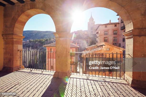 looking through arches to albarracin town with direct sunlight, albarracin, spain - albarracin stock pictures, royalty-free photos & images