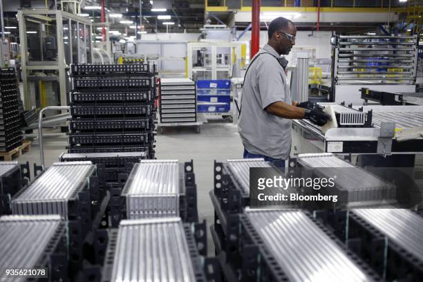 Worker assembles truck engine cooling module components at the MAHLE Behr Charleston Inc. Auto part facility in Charleston, South Carolina, U.S., on...