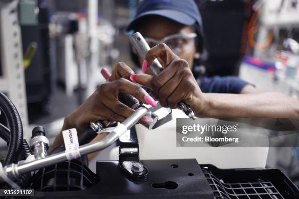 Worker assembles truck engine cooling module components at the MAHLE Behr Charleston Inc. Auto part facility in Charleston, South Carolina, U.S., on...