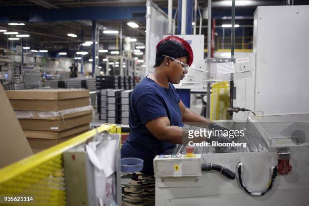 Worker assembles truck engine cooling module components at the MAHLE Behr Charleston Inc. Auto part facility in Charleston, South Carolina, U.S., on...