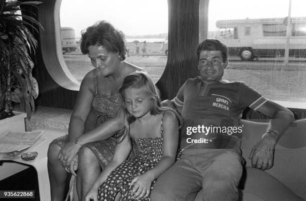 French cyclist Raymond Poulidor rests in a caravan with his wife Gisèle and his daughter Corinne, on July 14 at the end of the 18th stage...
