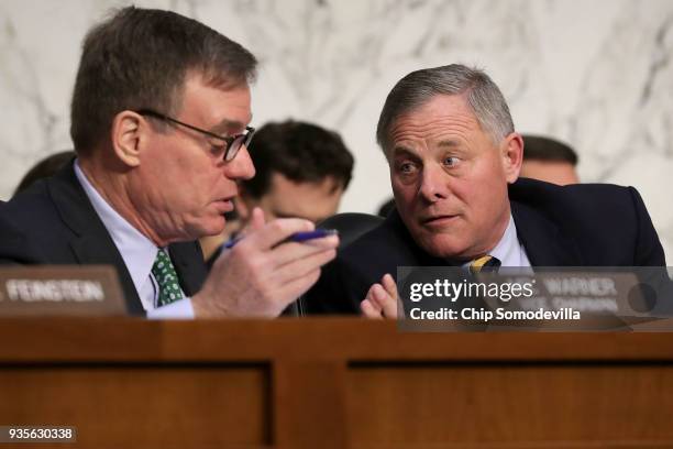 Senate Intelligence Committee anking member Sen. Mark Warner and Chairman Richard Burr confer during a committee hearing in the Hart Senate Office...