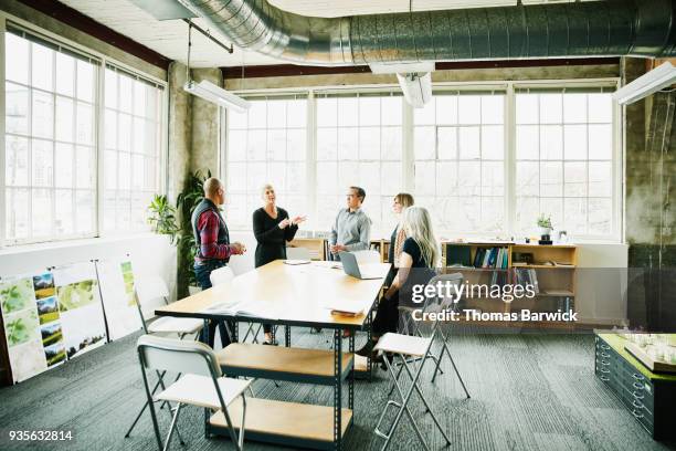 group of architects in project planning meeting in design office - 5 tips stockfoto's en -beelden