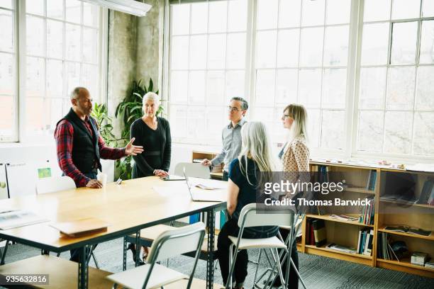 architect leading design planning meeting at conference table in office - design studio woman chinese laptop fotografías e imágenes de stock