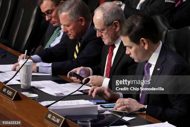 Senate Intelligence Committee members Sen. Marco Rubio and Sen. James Risch look at their phones during a committee hearing in the Hart Senate Office...