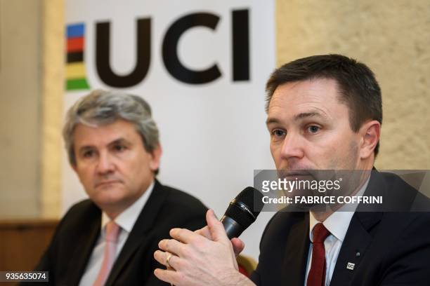 International Cycling Union president David Lappartient speaks next to CEA Tech deputy director Gabriele Fioni during a press conference unveilling a...