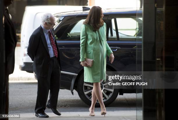 Britain's Catherine, Duchess of Cambridge is greeted by President of the Royal society of Medicine, Sir Simon Charles Wessely on her arrival for a...