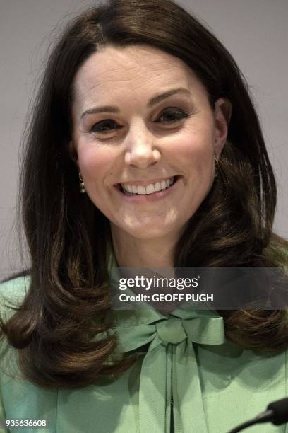 Britain's Catherine, Duchess of Cambridge addresses a symposium she convened with The Royal Foundation on early intervention for children and...