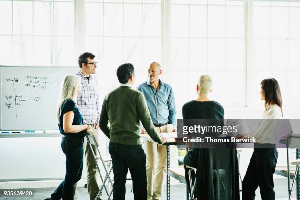 group of architects having project meeting in design studio conference room - group people thinking stock pictures, royalty-free photos & images